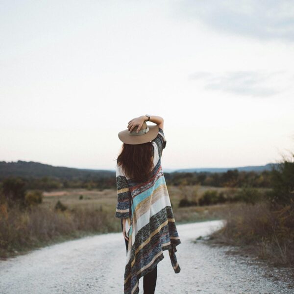 A hopeful woman in prayer, symbolizing the emotional journey of waiting and embracing God's timing in the motherhood journey, inspired by the story of Sarah in Genesis 21:6.