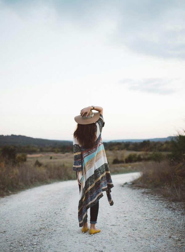 A hopeful woman in prayer, symbolizing the emotional journey of waiting and embracing God's timing in the motherhood journey, inspired by the story of Sarah in Genesis 21:6.